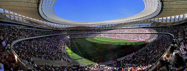 Crowds surrounding the rugby pitch at Cape Town Stadium during a Stormers fixture