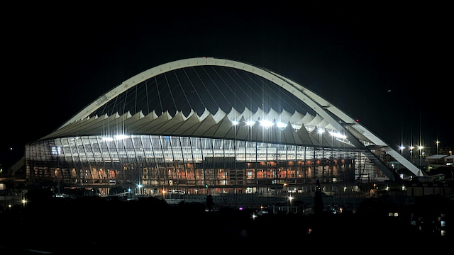 Moses Mabhida Stadium illuminated beneath its sweeping arch at night in Durban