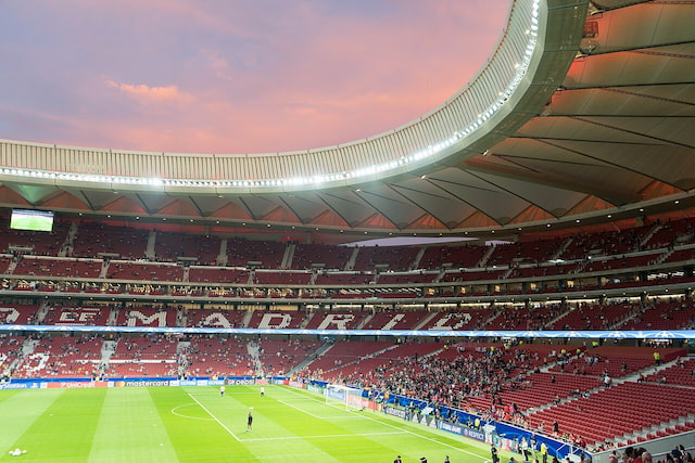 Metropolitano Stadium in Madrid under floodlights at sunset