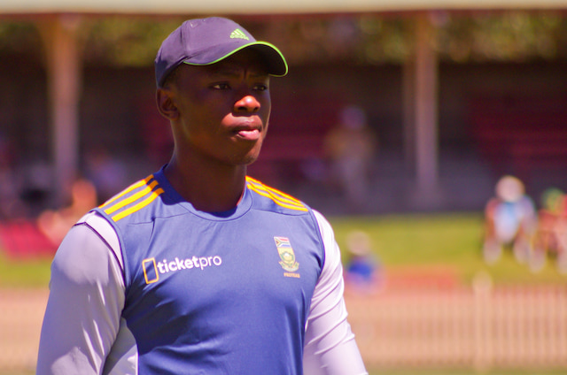 Kagiso Rabada wearing a South Africa training shirt and cap at a cricket ground.