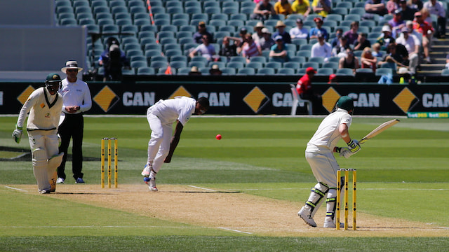Kagiso Rabada releases a delivery as an Australian batter prepares to play during a Test match.