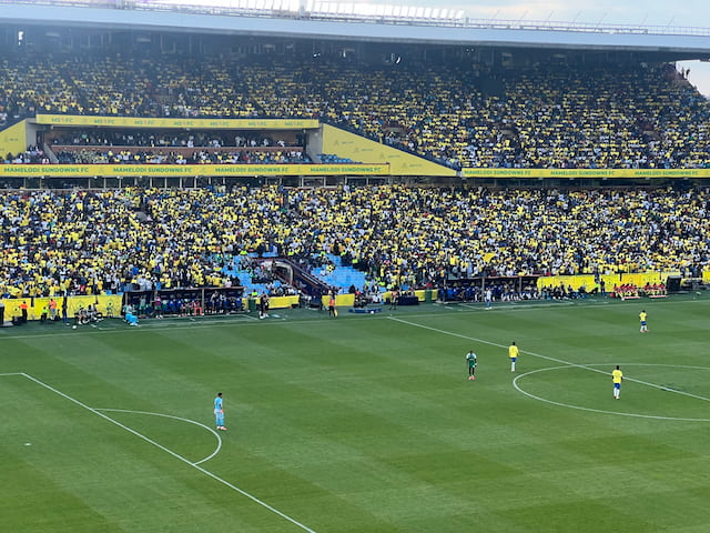 Yellow-clad Mamelodi Sundowns supporters fill the Loftus Versfeld stands during a match against Al Ahli in September 2026.
