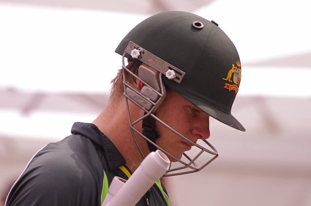 Steve Smith wearing an Australia cricket helmet and training shirt.